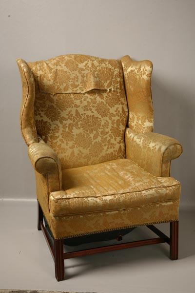 Appraisal: CHIPPENDALE-STYLE WING CHAIR Twentieth century mahogany Molded legs and yellow