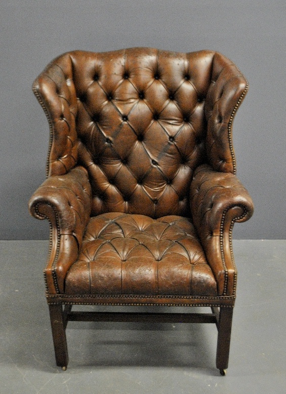 Appraisal: - English Chippendale style wingchair with brown tufted leather upholstery