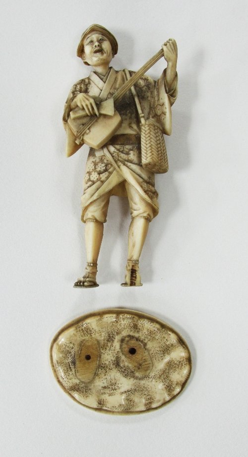 Appraisal: A Japanese ivory okimono Meiji period depicting a standing musician