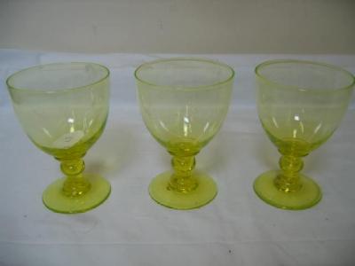 Appraisal: A SET OF THREE YELLOW GLASS RUMMERS the plain bowls