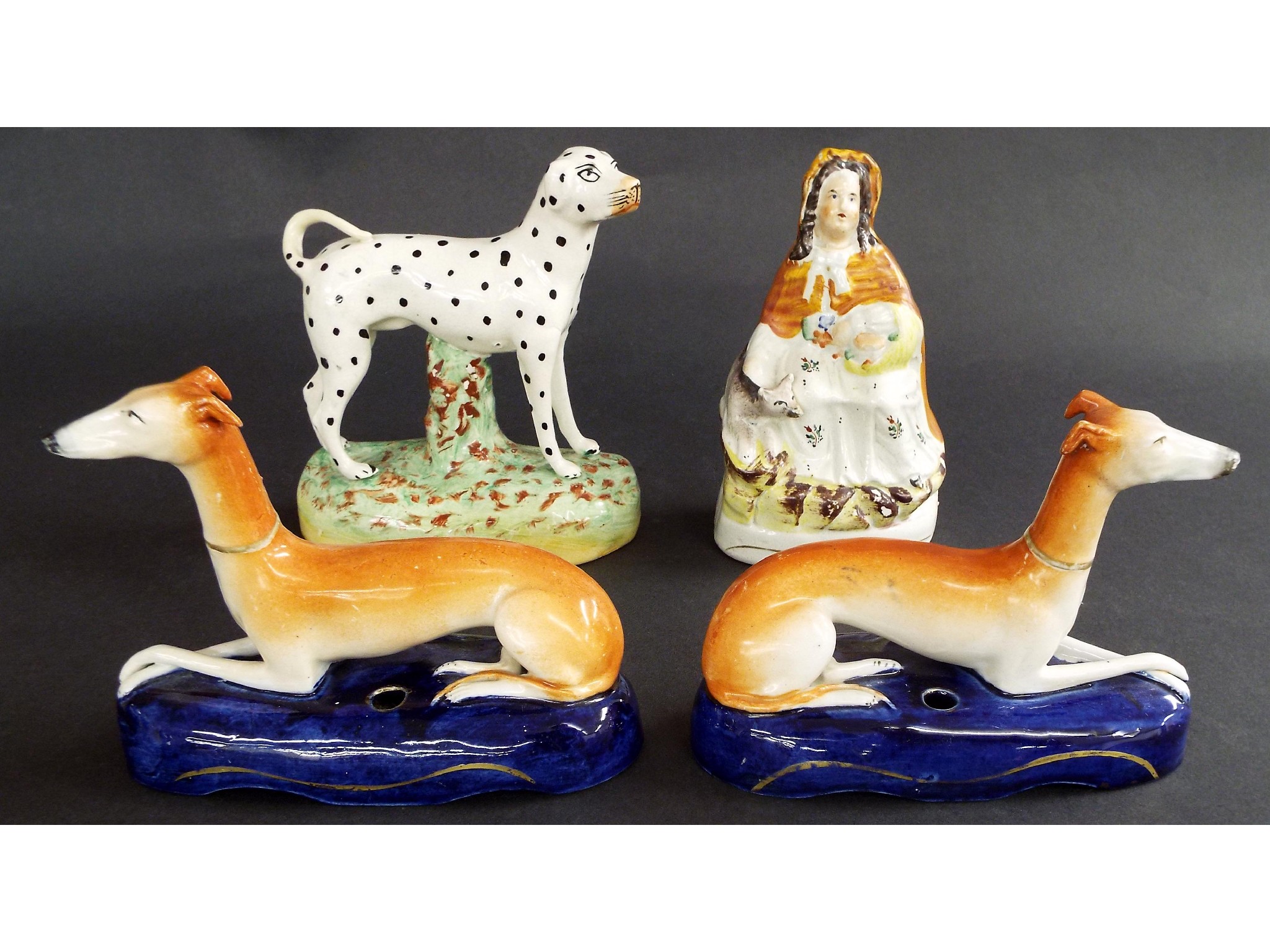 Appraisal: Pair of Staffordshire recumbent greyhounds upon cobalt blue bases with