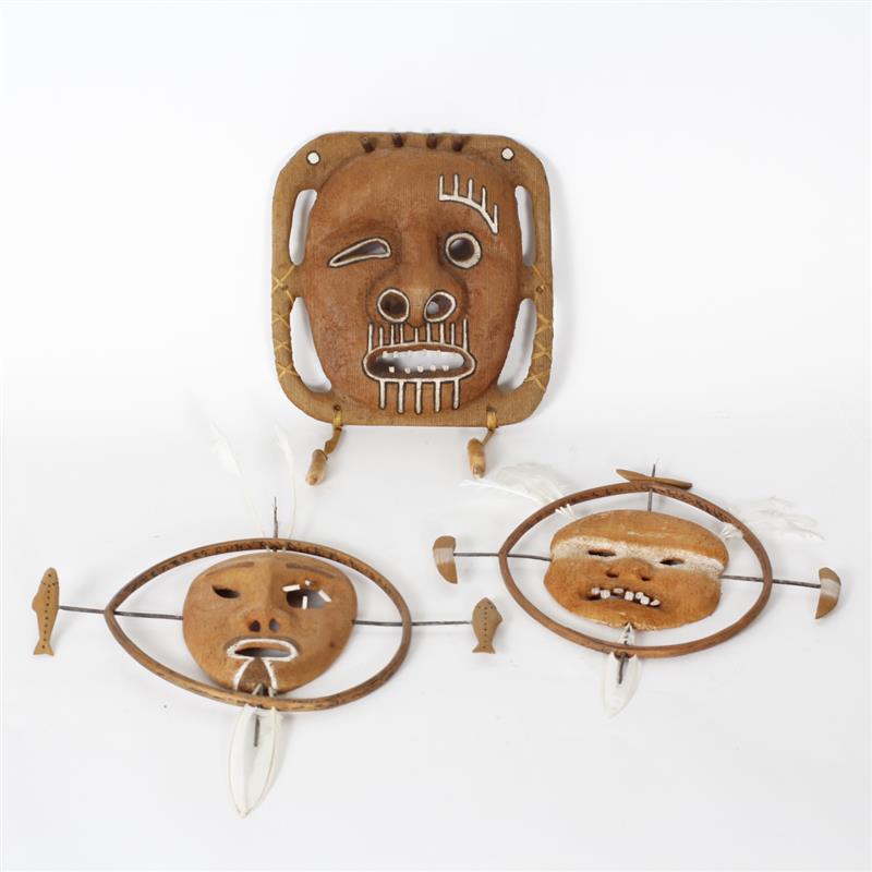 Appraisal: Three Alaskan Inuit carved wood decorative masks with feather stone