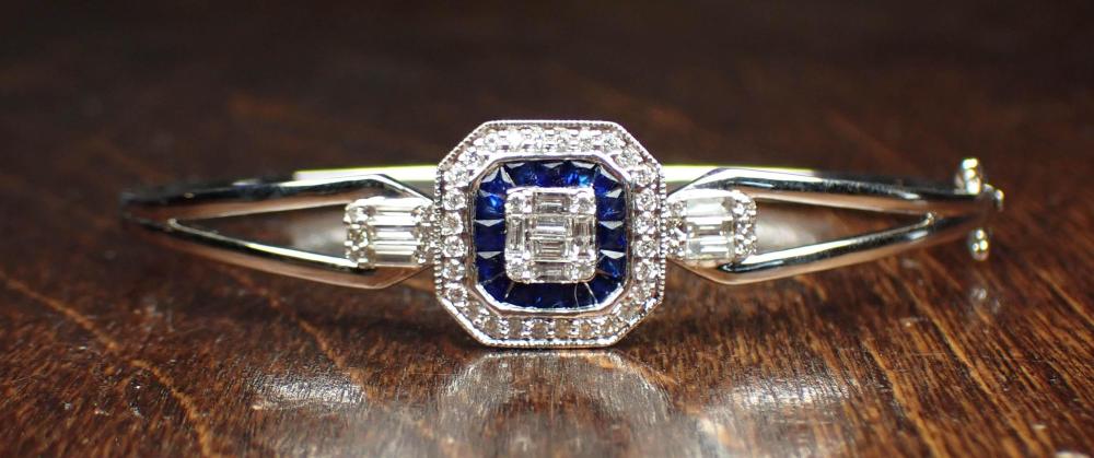 Appraisal: DIAMOND SAPPHIRE AND EIGHTEEN KARAT GOLD BANGLE The oval hinged