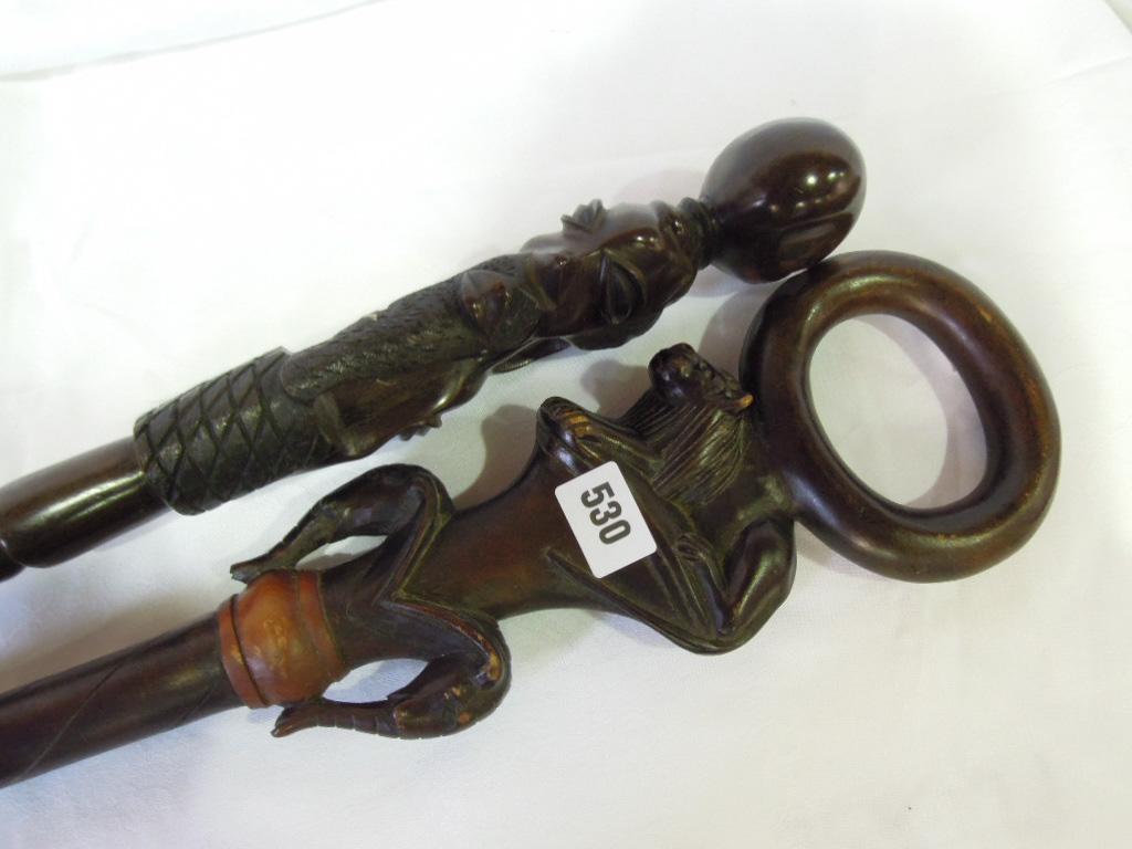 Appraisal: An African carved walking stick with lion and elephant handle