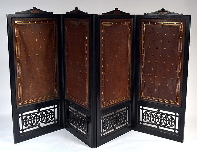 Appraisal: An Aesthetic Movement ebonised four fold screeneach section with leather