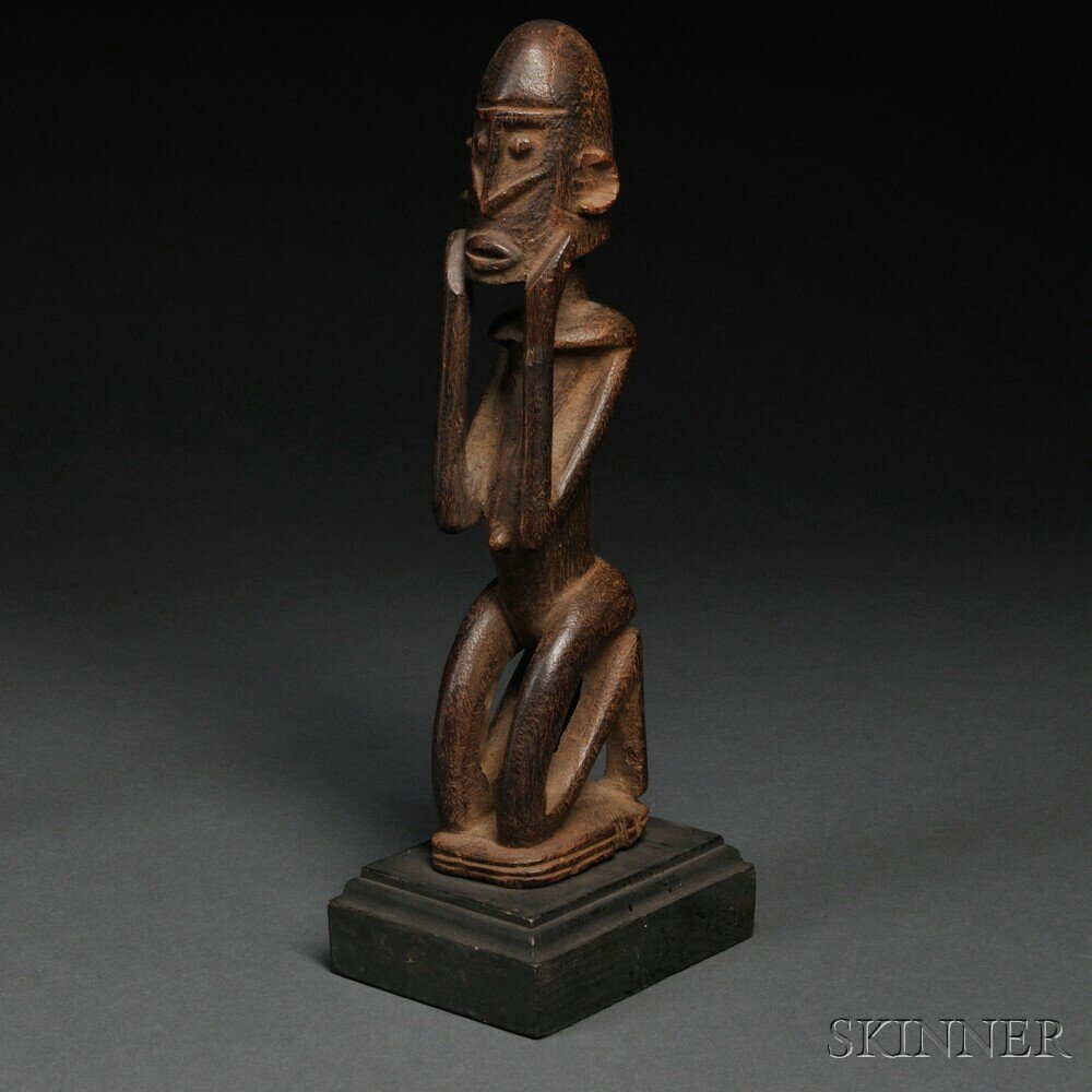 Appraisal: Dogon Carved Wood Figure the stylized kneeling figure with hands