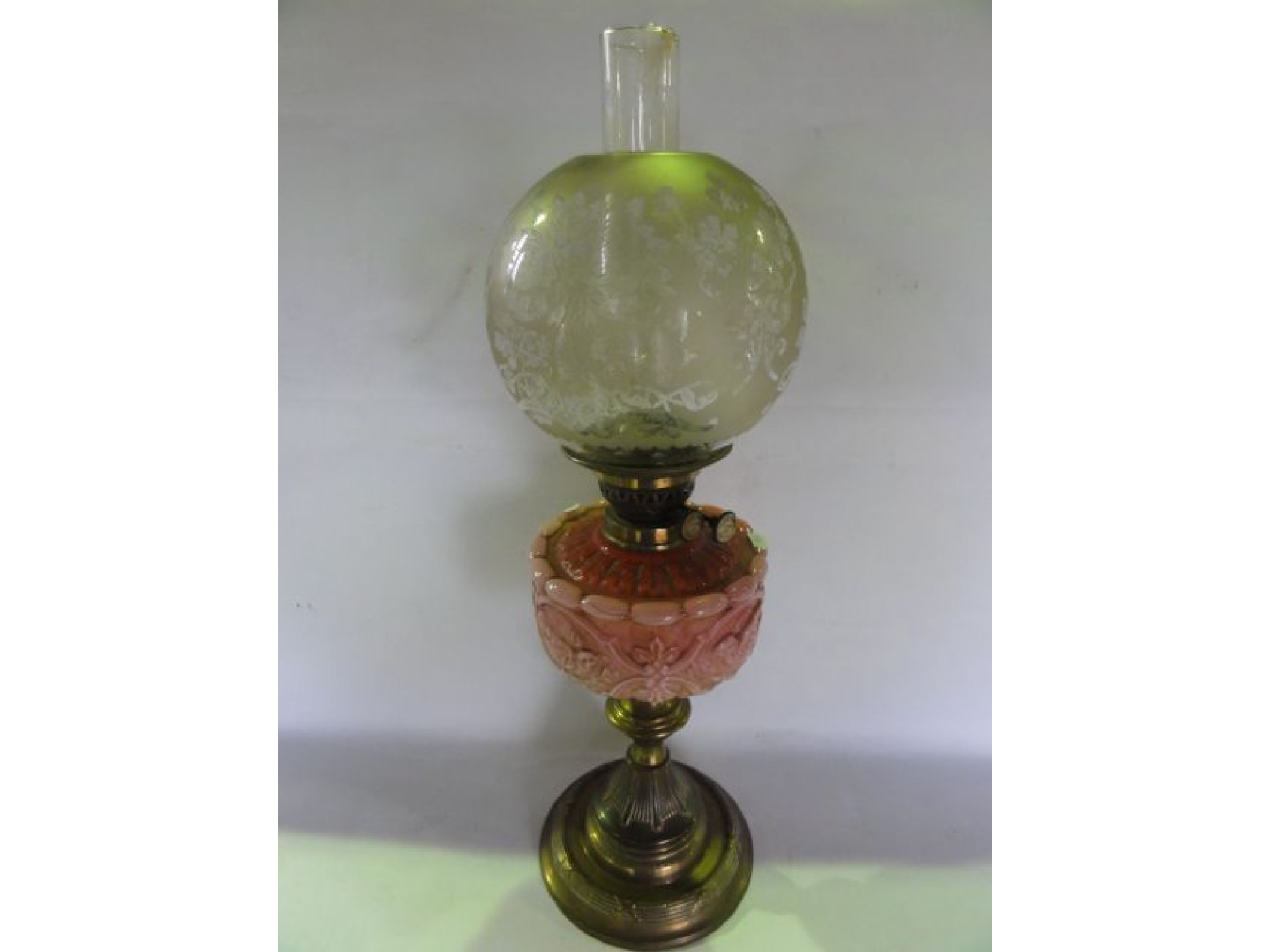 Appraisal: A Victorian oil lamp raised on a brass stem with