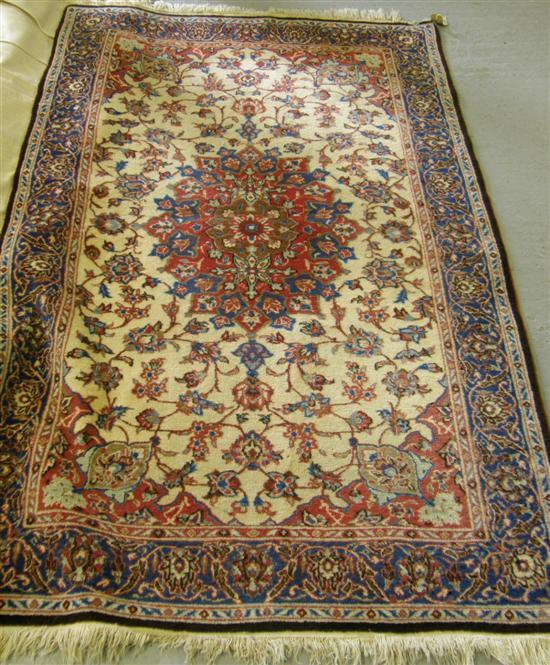 Appraisal: Cream ground Persian rug with a central flower-shaped cartouche and