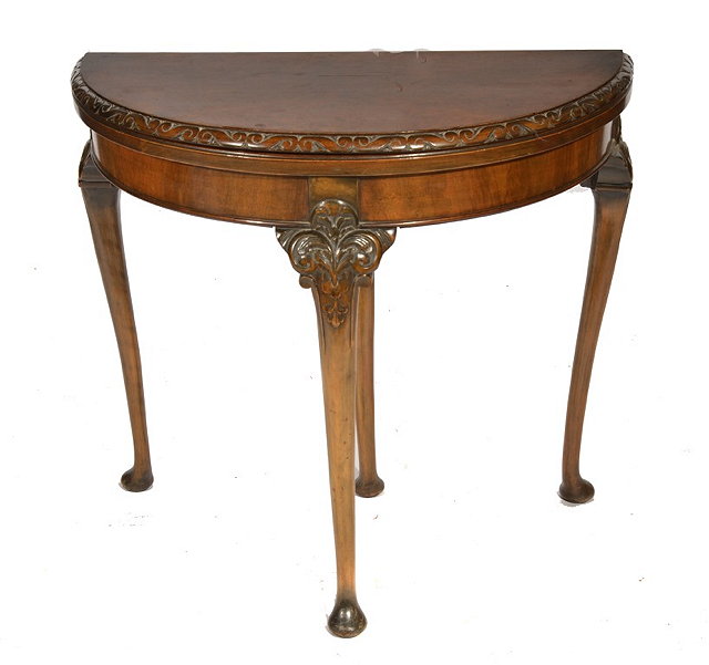 Appraisal: A VICTORIAN DEMI-LUNE WALNUT CARD TABLE with fold-over top and