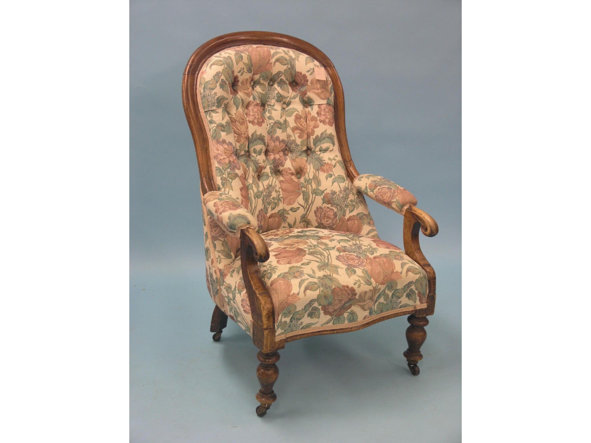 Appraisal: A Victorian mahogany-framed spoon-back elbow chair on front turned legs