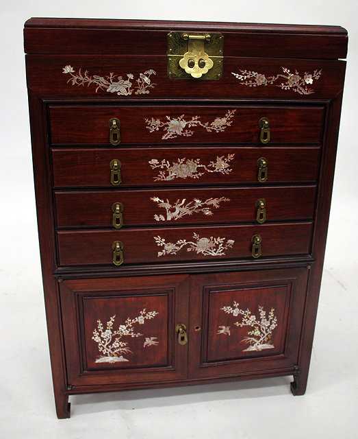 Appraisal: AN ORIENTAL HARDWOOD CANTEEN CABINET with mother of pearl prunus