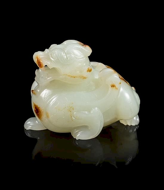 Appraisal: A Celadon and Russet Jade Carving of a Mythical Beast