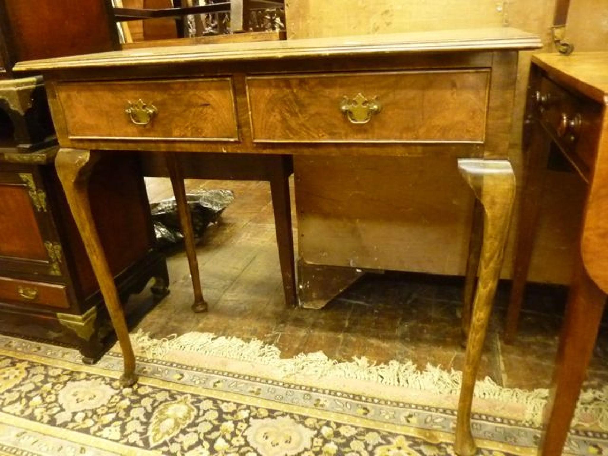 Appraisal: A walnut side table of rectangular form with cross banded