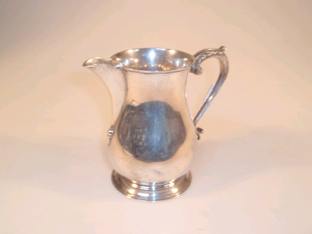 Appraisal: A George VI silver pear shaped jug with an acanthus