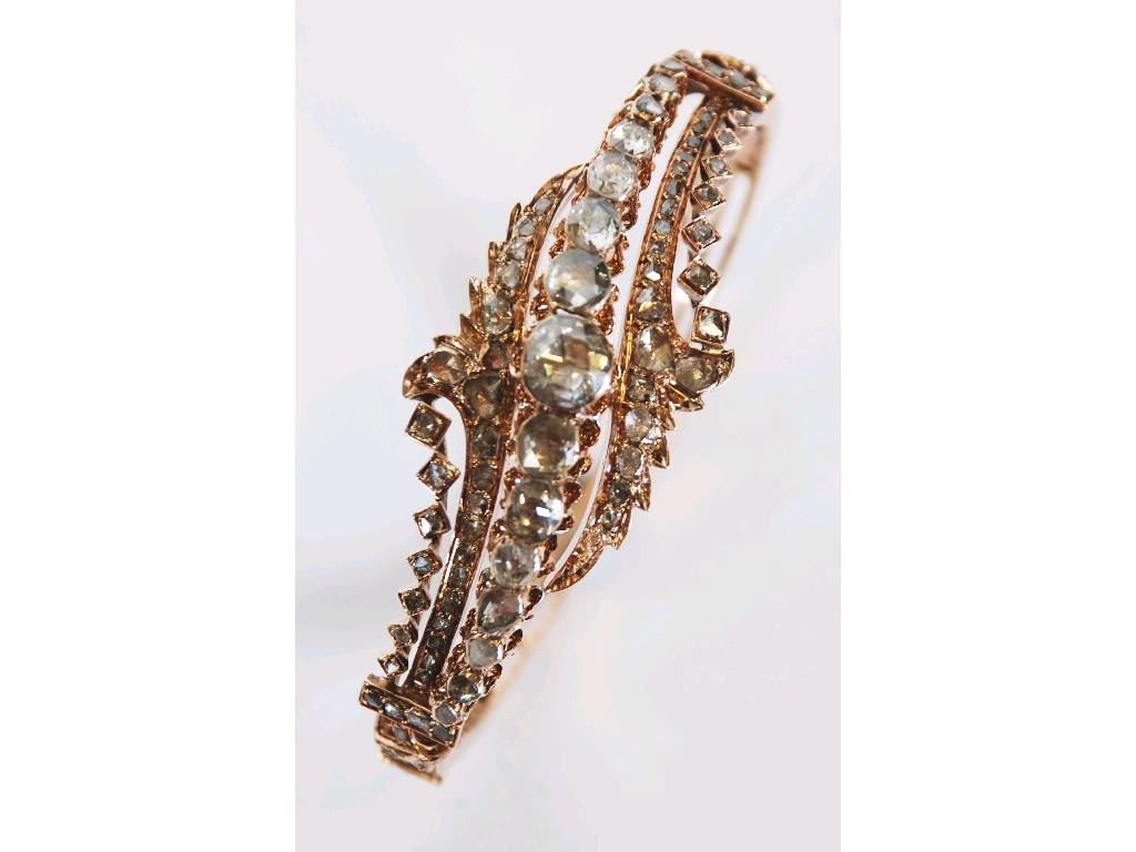 Appraisal: NINETEENTH CENTURY GOLD AND DIAMOND HINGE OPENING TRIPLE STRAND BANGLE