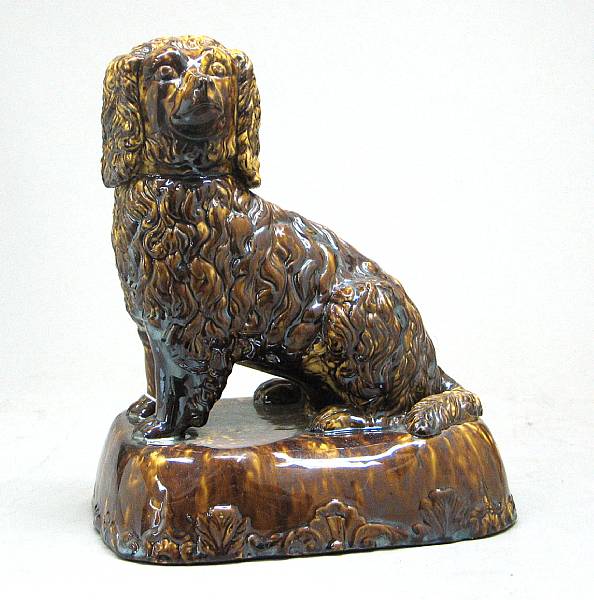 Appraisal: A Rockingham type glazed yellow earthenware spaniel second half th