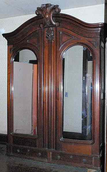 Appraisal: Massive Victorian walnut armoire with a heavily carved cornice above