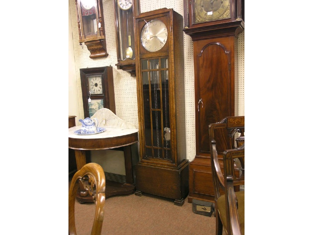 Appraisal: A 's oak longcase clock featuring silvered dial and chiming