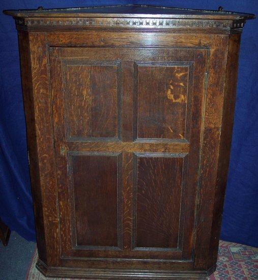 Appraisal: A th Century oak hanging corner cupboard with four panel