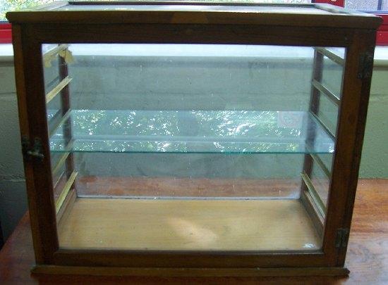 Appraisal: A tradesman's display cabinet with glazed top and sides the