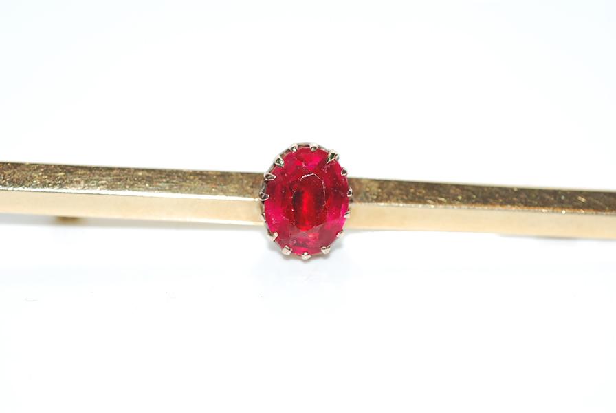 Appraisal: A GARNET TOPPED DOUBLET SET BAR BROOCH IN CT GOLD