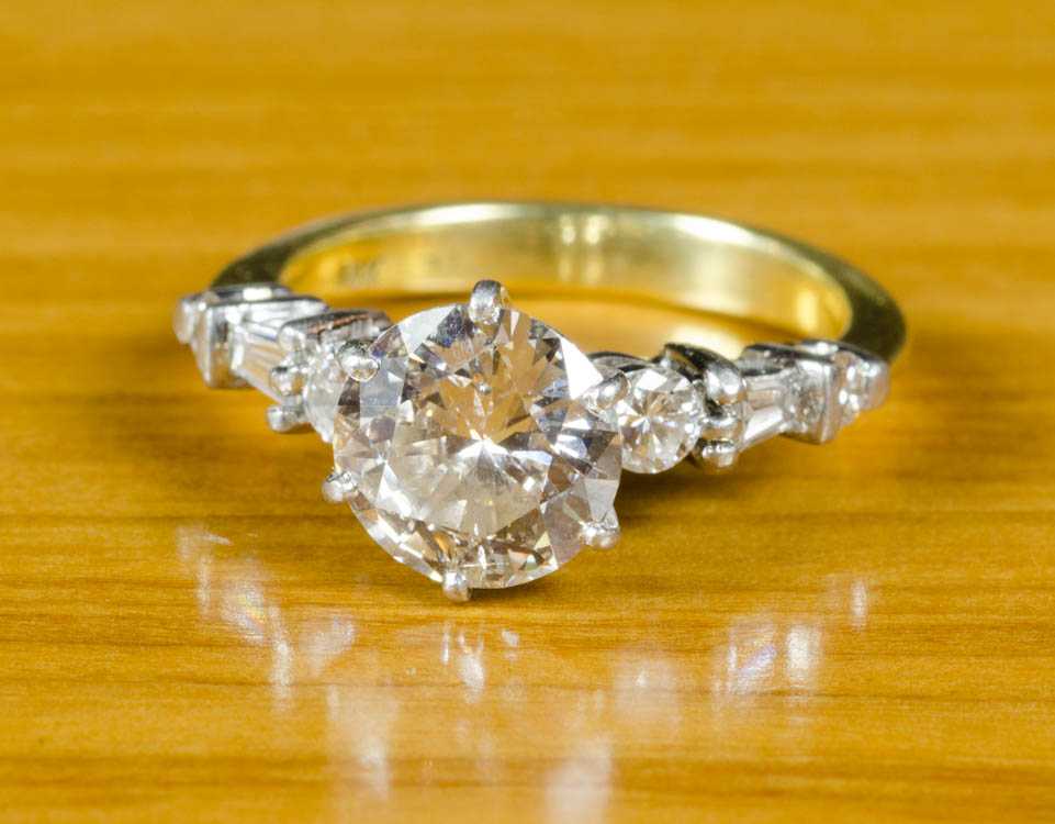 Appraisal: AN ESTATE DIAMOND RING WITH APPRAISAL platinum and K yellow