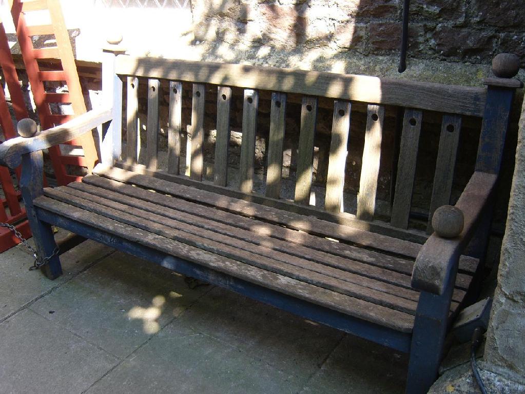 Appraisal: A weathered Lister teakwood garden bench with slatted seat shaped