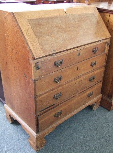 Appraisal: A George III oak bureau of small proportions the fall