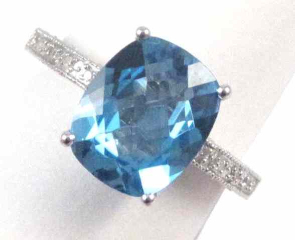 Appraisal: BLUE TOPAZ DIAMOND AND FOURTEEN KARAT GOLD RING featuring a