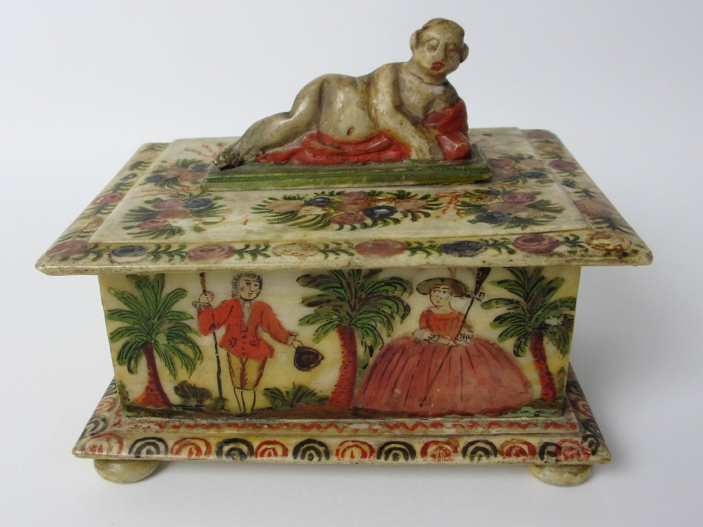 Appraisal: A polychrome and alabaster box with recumbent female figure amongst