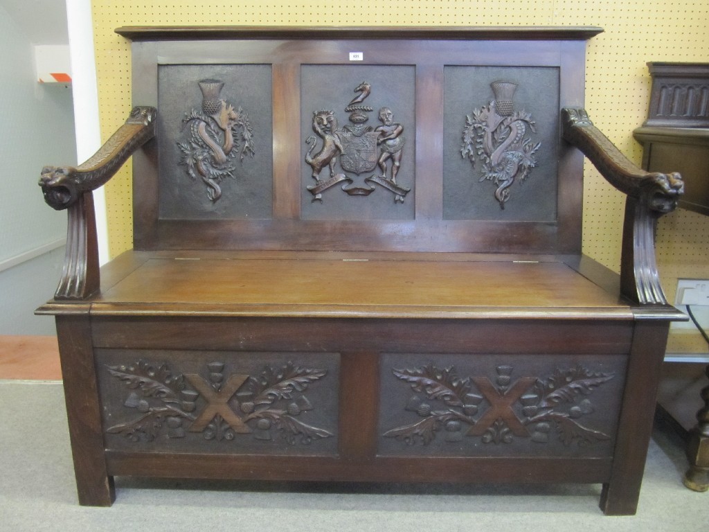 Appraisal: Carved mahogany hall settle bearing a coat of arms motif