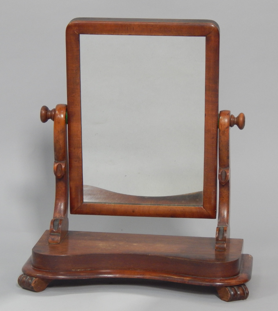 Appraisal: A Victorian mahogany swing frame toilet mirror raised on a