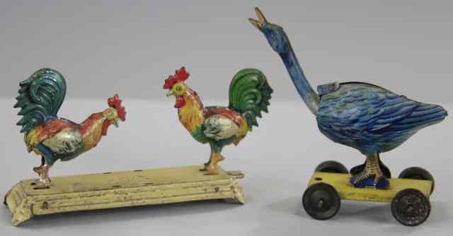 Appraisal: ROOSTERS AND GOOSE PENNY TOYS Meier pecking rooster on platform