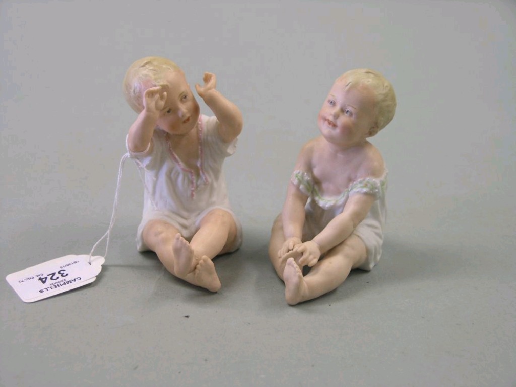 Appraisal: A pair of early th century bisque porcelain Piano Babies