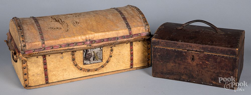 Appraisal: Two hide and leather covered dome lid trunks Two hide