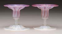 Appraisal: PAIR TIFFANY PASTEL CANDLESTICKS Amethyst stretched glass with white opalescent