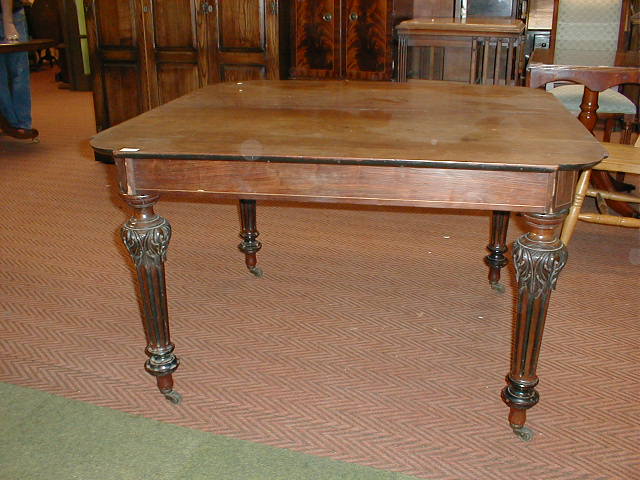 Appraisal: A thC mahogany dining table with ebonised and fluted legs