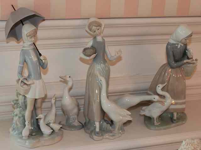 Appraisal: THREE LLADRO PORCELAIN FIGURES of girls one holding an umbrella