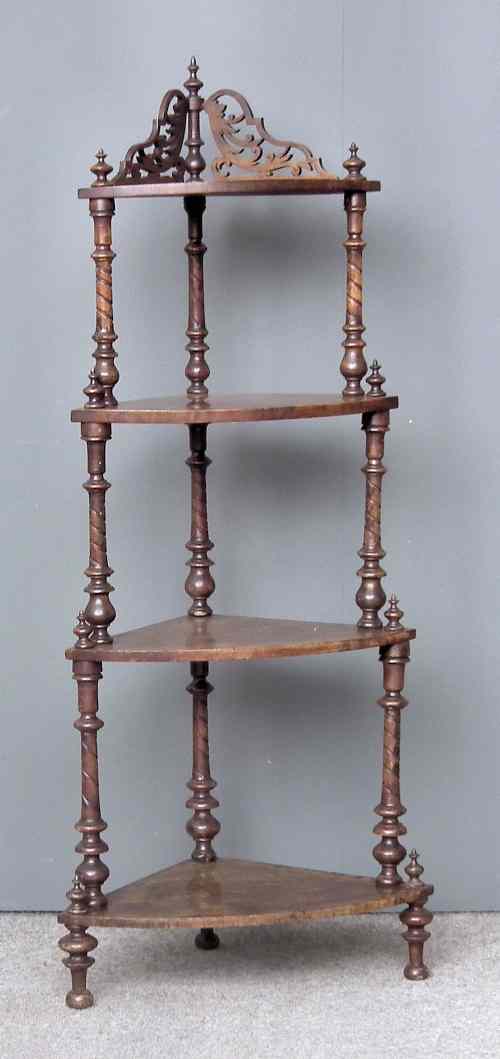 Appraisal: A Victorian figured walnut bow-fronted and graduated four tier corner