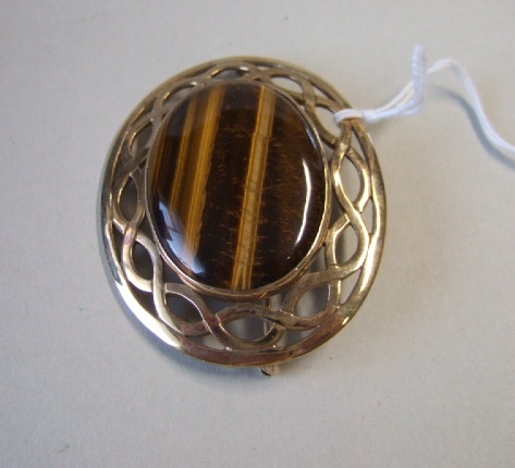 Appraisal: A ct gold mounted oval tiger's eye brooch with a