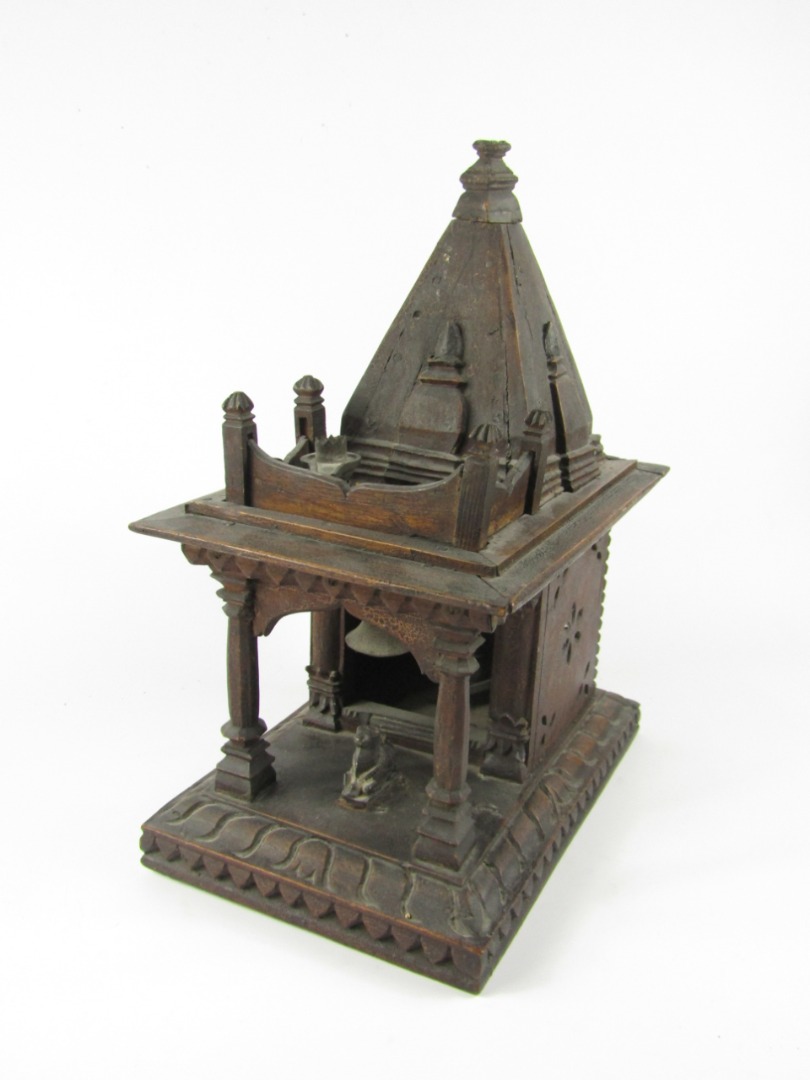 Appraisal: An Eastern carved hardwood temple shrine raised on a rectangular