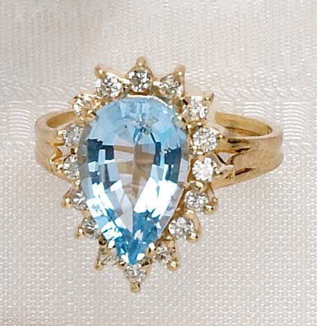 Appraisal: BLUE TOPAZ AND DIAMOND RING k yellow gold ring set