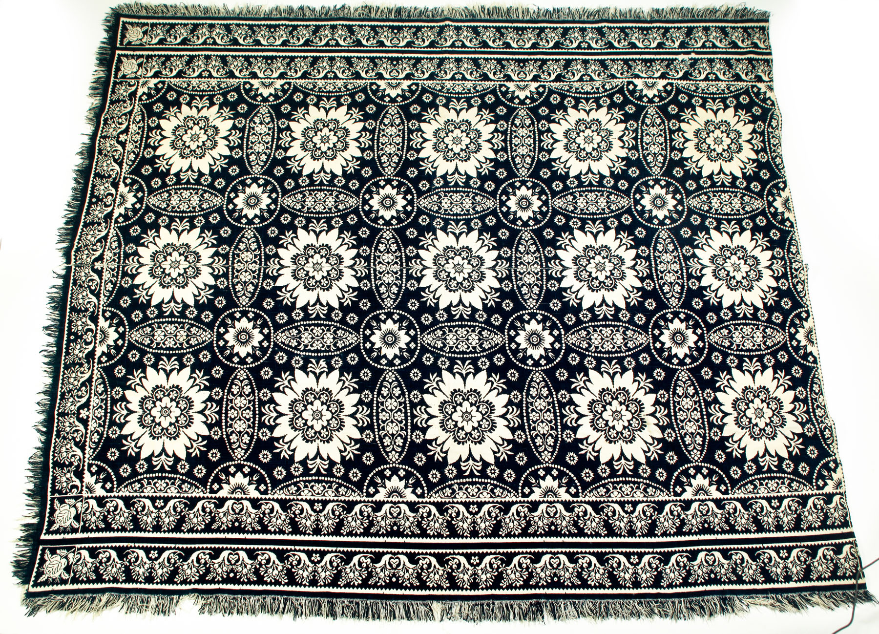 Appraisal: INDIGO AND WHITE JACQUARD COVERLET American mid th century cotton