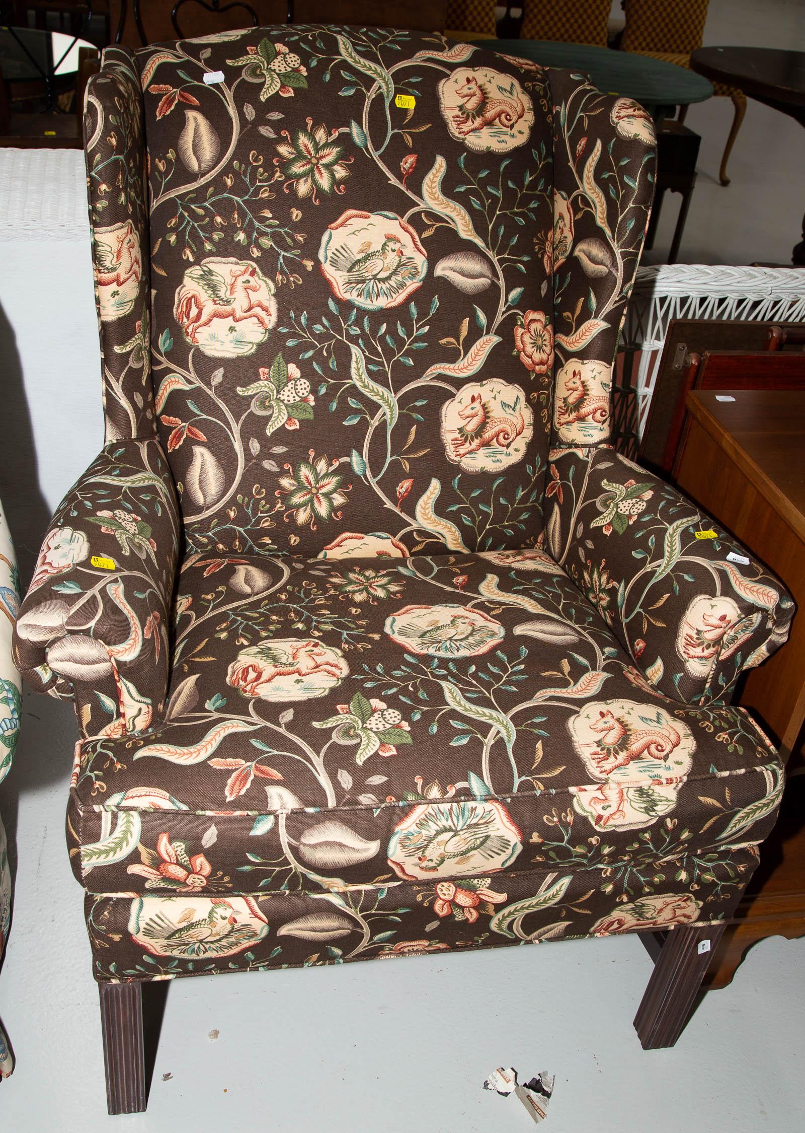 Appraisal: A FLORAL UPHOLSTERED WING CHAIR Approximately in H