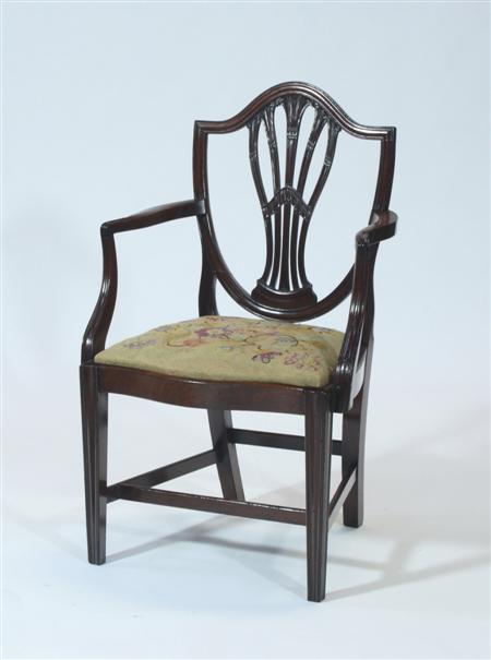 Appraisal: A George III mahogany open armchair the moulded shield back