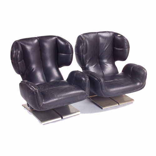 Appraisal: Pair of black leather upholstered wing lounges s on aluminum