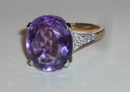 Appraisal: AN AMETHYST AND DIAMOND RING the large oval cut amethyst