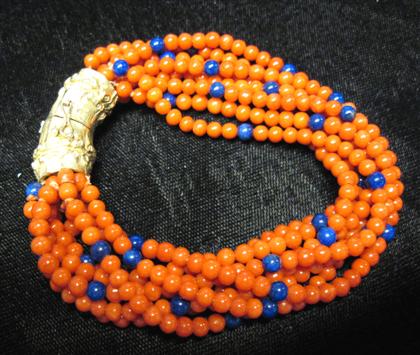 Appraisal: karat yellow gold coral and lapis braceletEight strand coral and