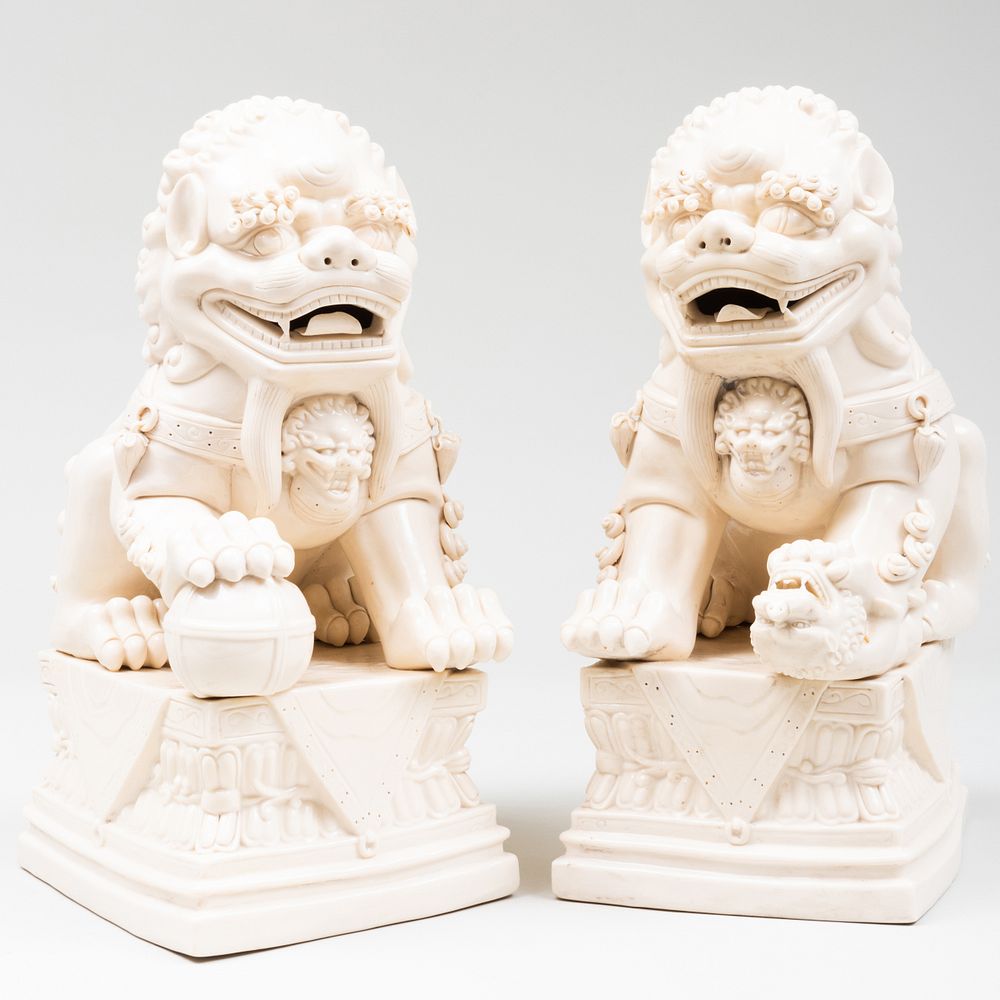 Appraisal: Pair of Chinese White Glazed Porcelain Buddhistic Lions x x