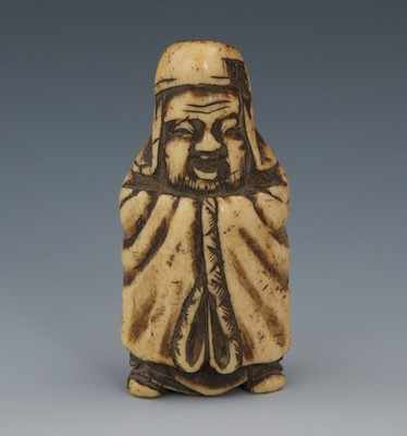 Appraisal: A Carved Staghorn Netsuke of Robed Figure Smiling man in